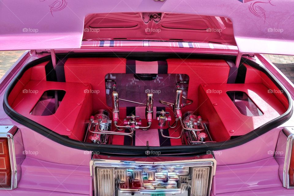 In the truck of a pink Cadillac 