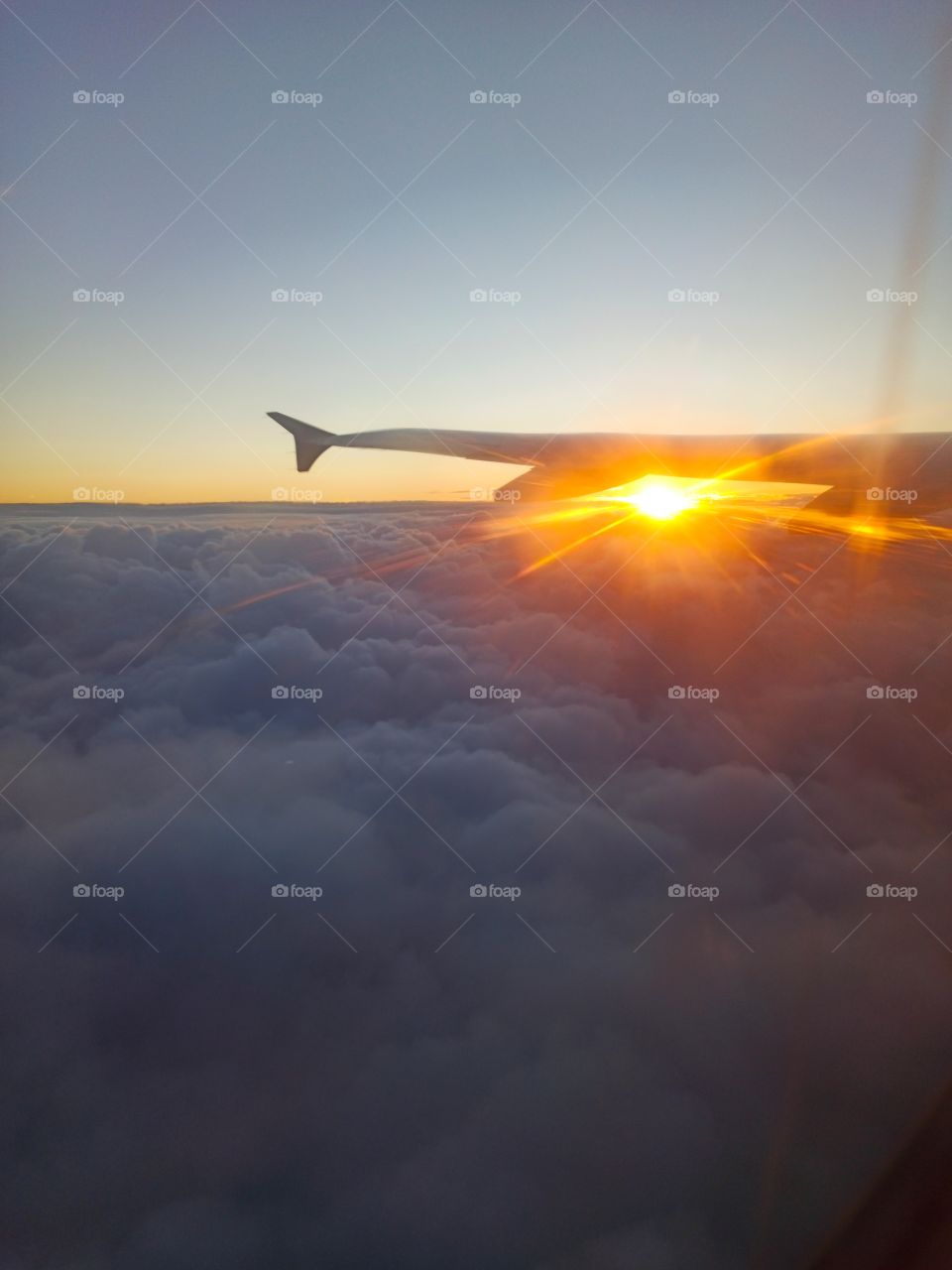 rising sun under airplane wing