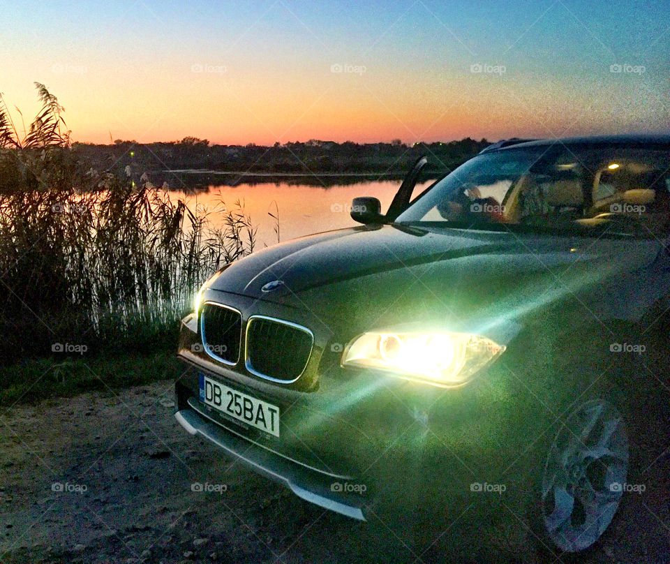 Beautiful car by the lake in the dawn