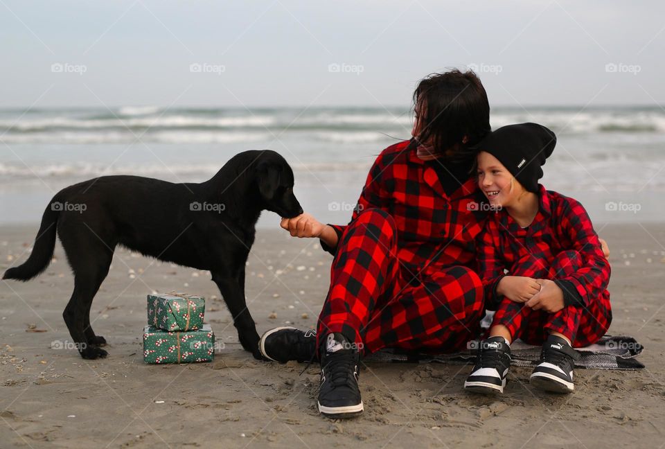 Happy together, mom, her son and dog, amazing time near the sea