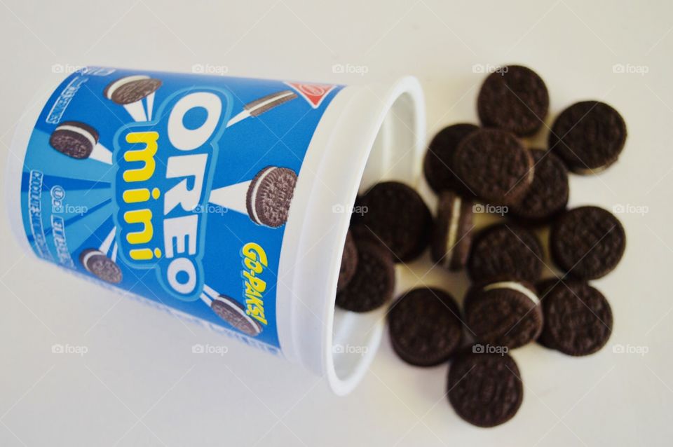 Oreo mini cookies go pack open container with spilled cookies 