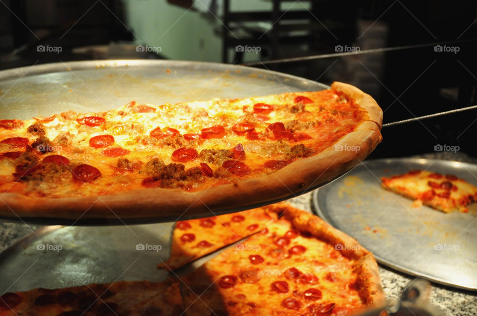 Fresh out of the oven tasty pepperoni and sausage pizza. 