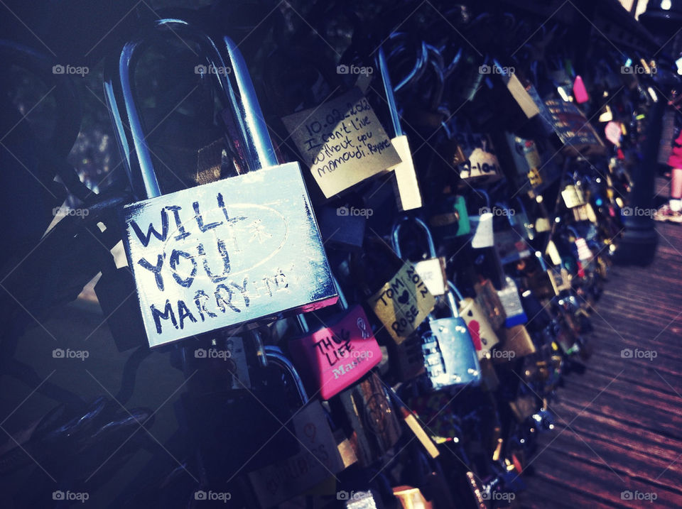 Will You Marry Me lock on the lover's lock bridge in Paris, France.