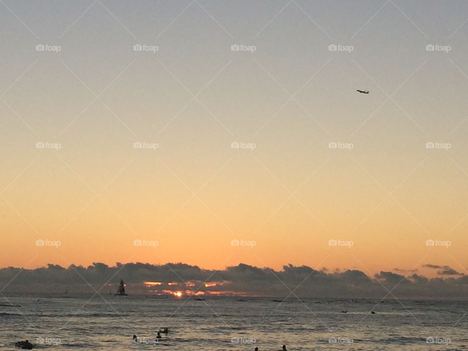 Sunset with a plane. At Waikiki Beach
