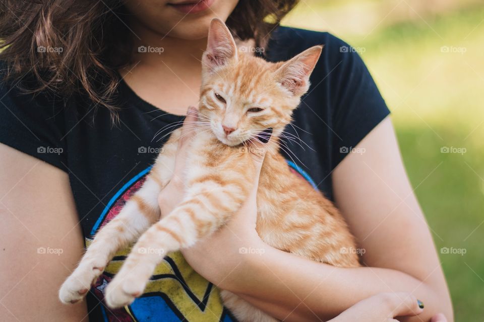 girl holding a kitten