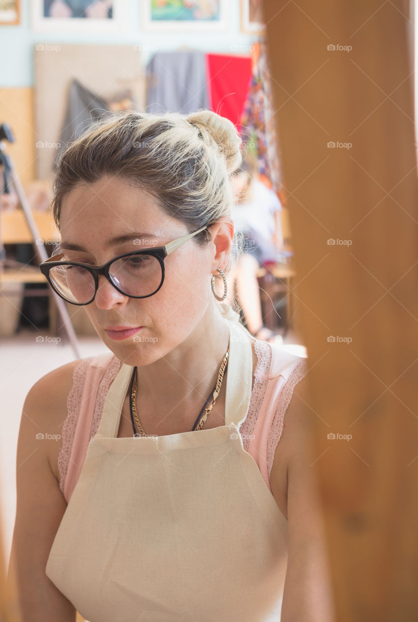 Portrait of young adult woman artist in working creative process