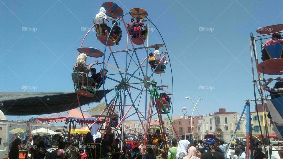 Crowd of people enjoying themselves with the wheels