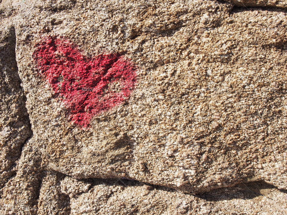 Heart shape drawing on rock