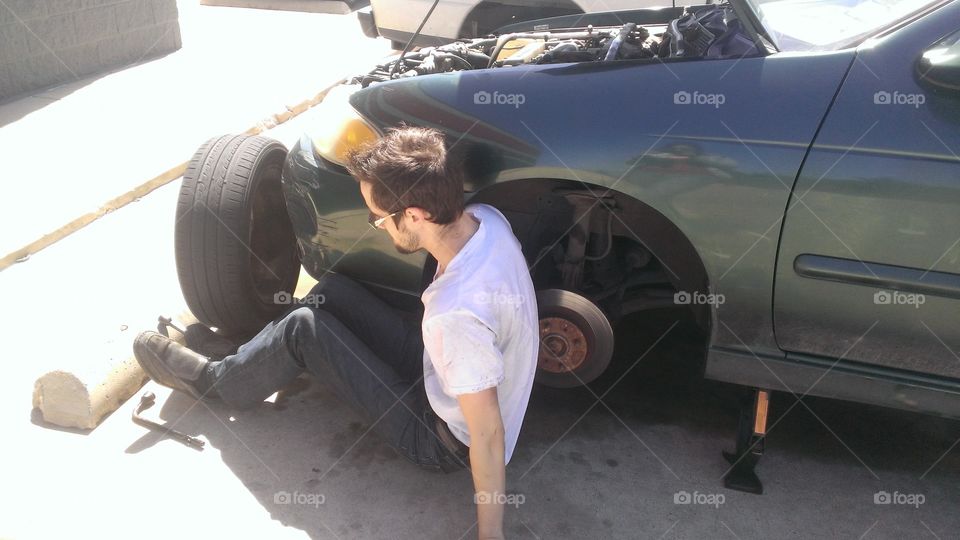Working on the car. Brake pads were going out.