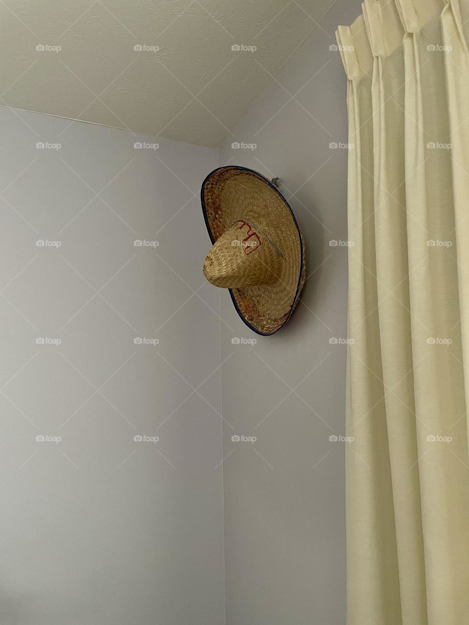 Hat on a wall, why is there a hat on the wall, out of place items, hats on walls 