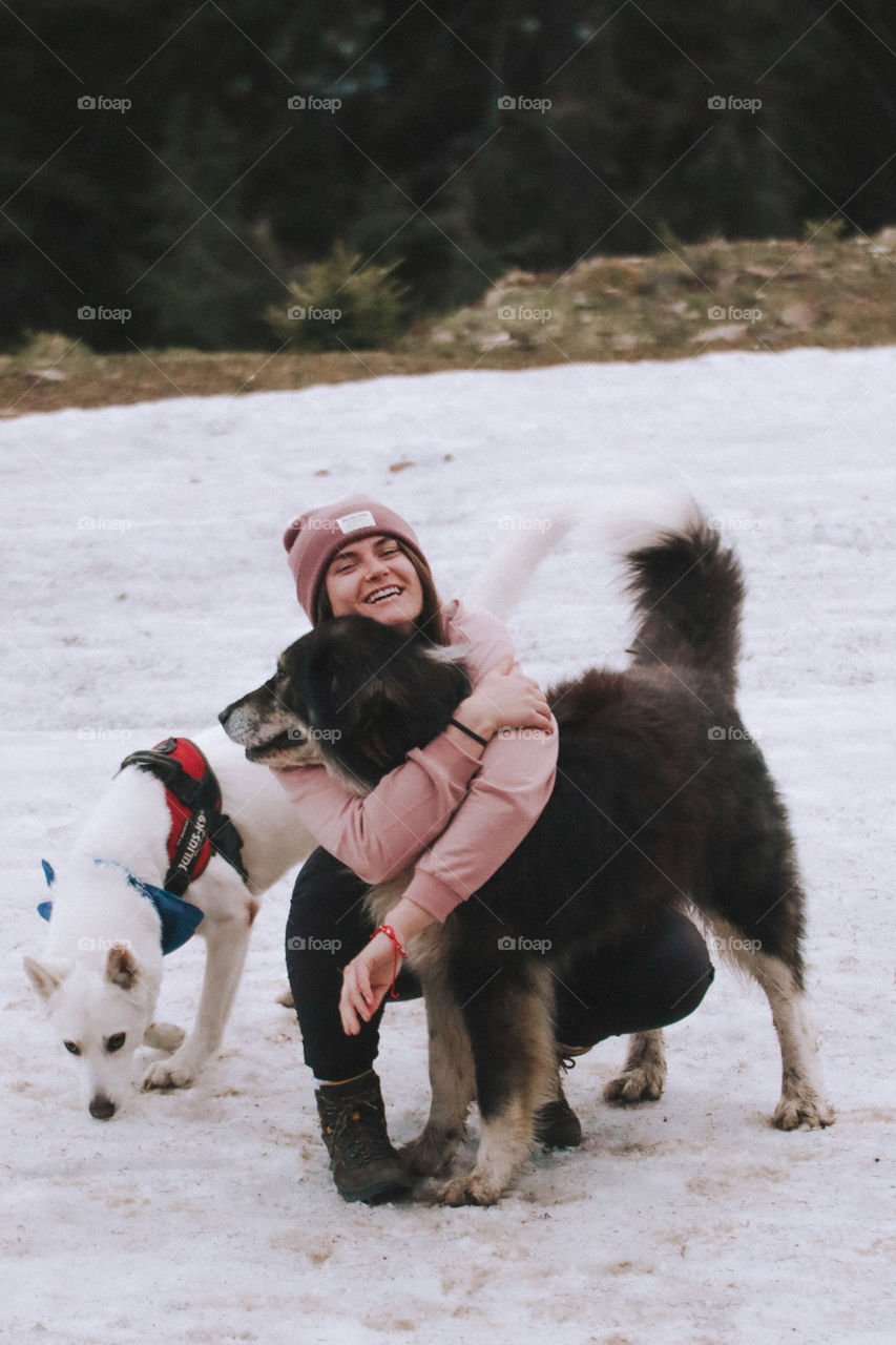 woman cuddling a dog