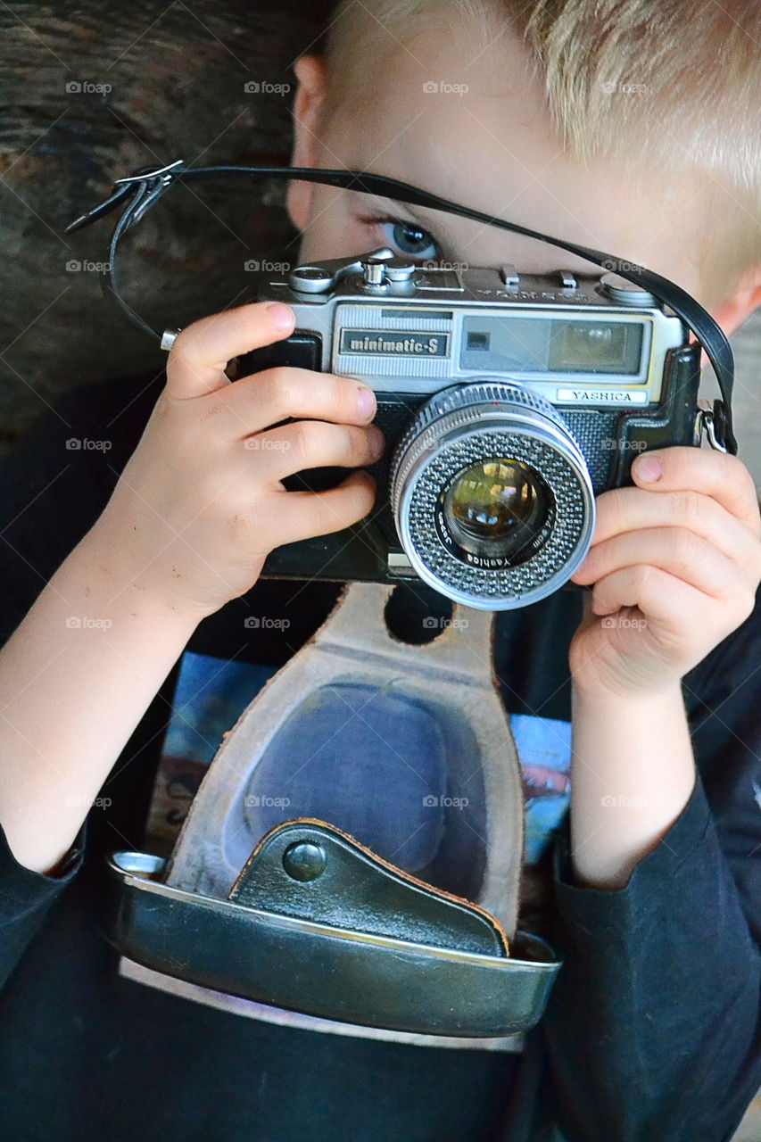 Boy with a vintage camera