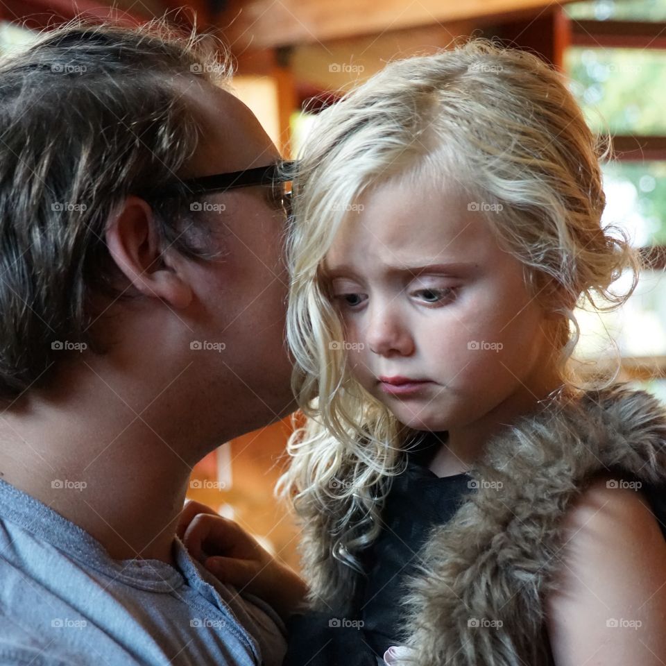 Close-up of a man holding blonde daughter