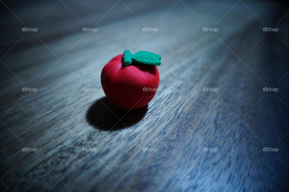 An apple on the table-cold tone.