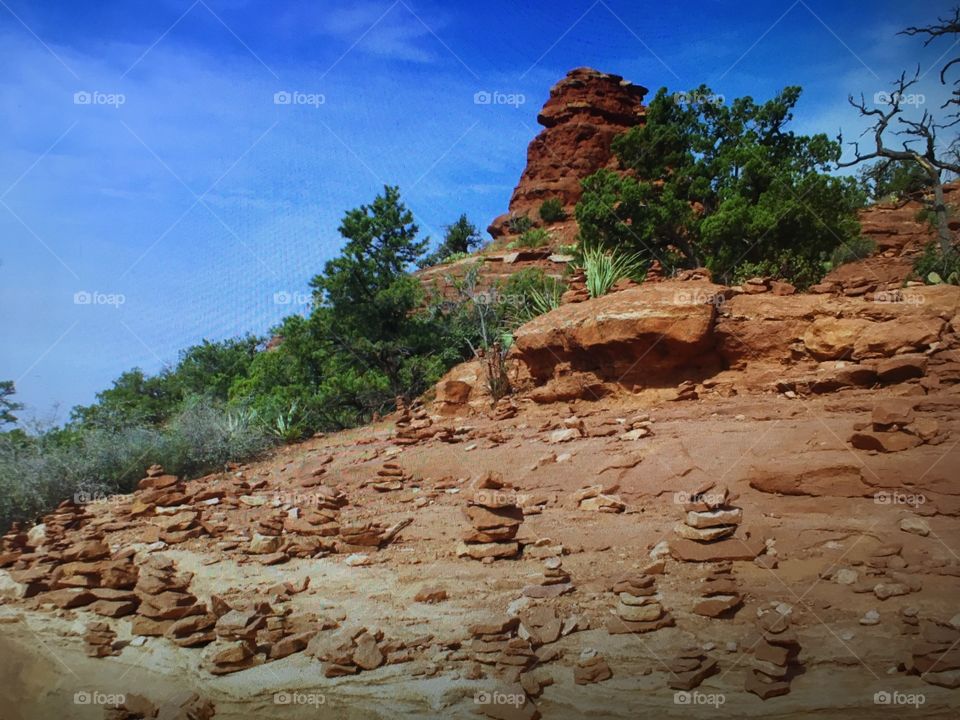 This is one of the vortex locations surrounding Sedona, Arizona. Notice all the cairns people leave behind to mark the spot. It’s a typical sight around these locations, left by people meditating near the vortex.