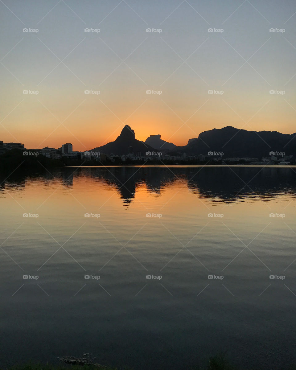 Sunset at Rodrigo de Freitas lagoon, Rio de Janeiro, Brazil. When the sun goes down, beauty is seen not only in the sky, but in the reflection of lagoon, witch makes it look like a mirror. 