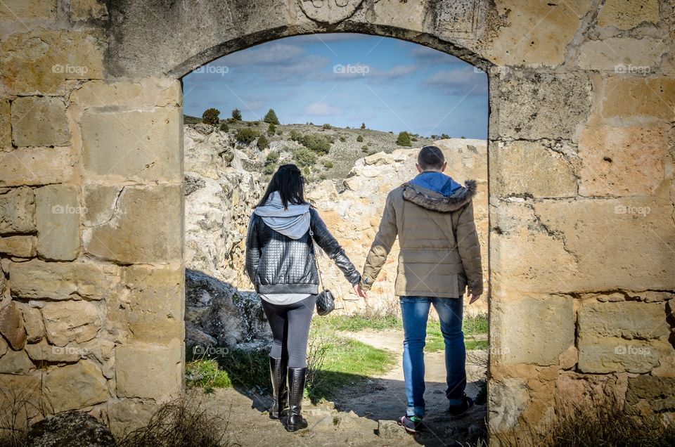 Couple walking through the arch 