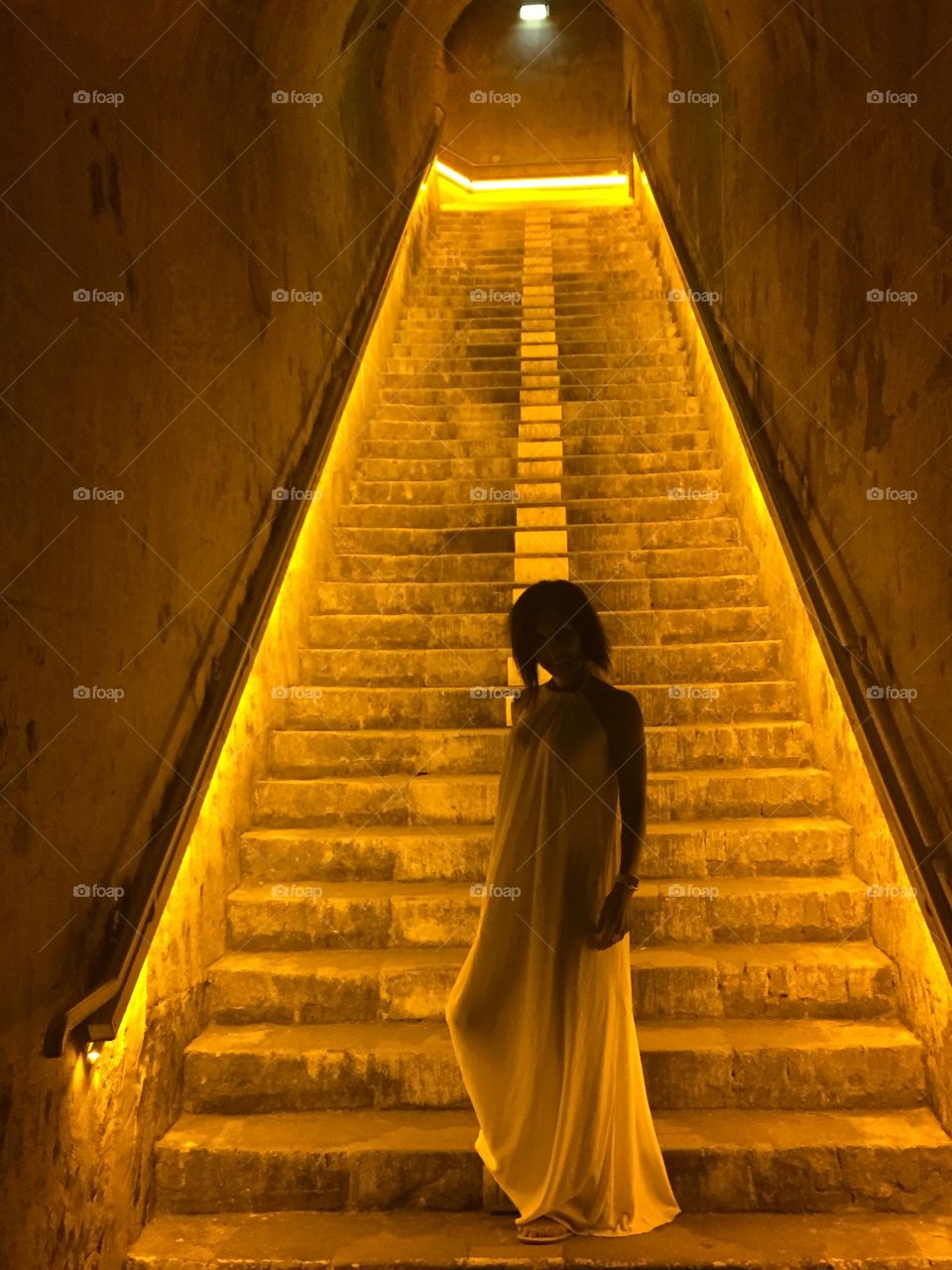 Along the steps of the wine cellar at Veuve Clicquot in France. The lighting and yellow background made for this mysterious goddess-like photo. 
