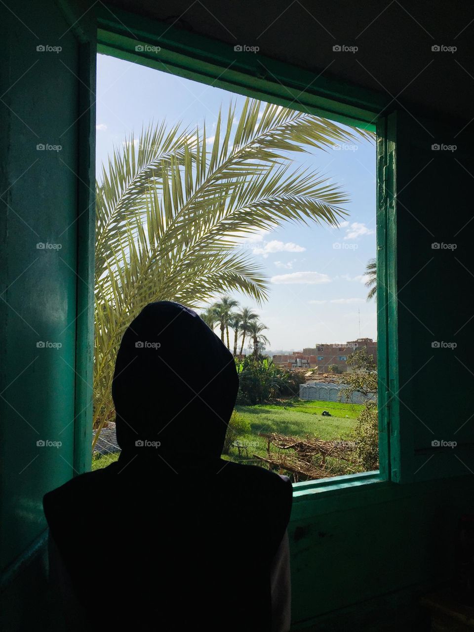 A girl is looking from a window