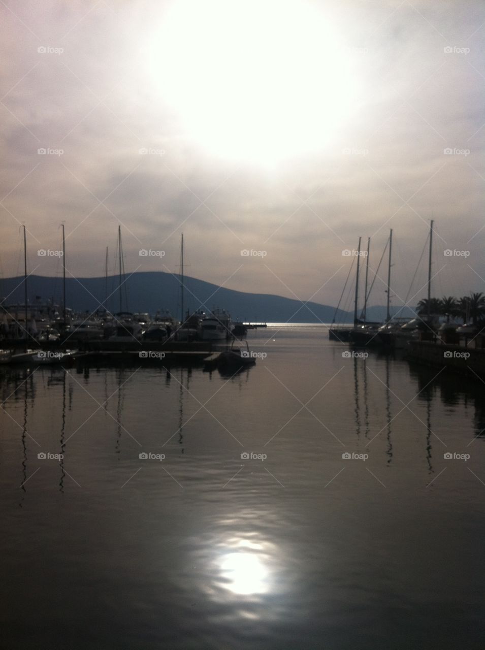 Sun reflection in the sea at the marina