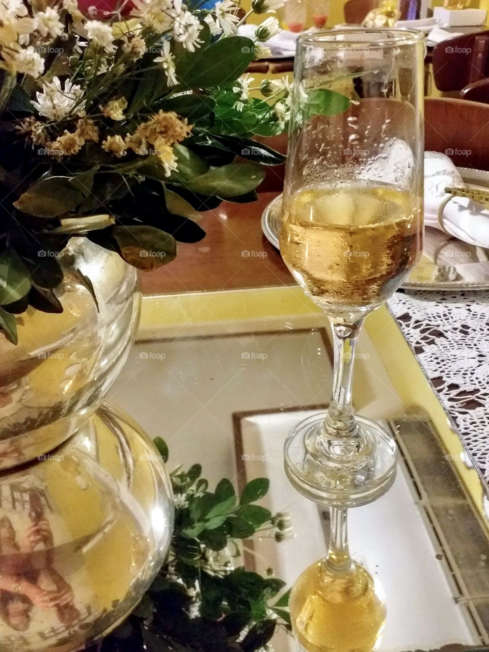Champagne glass on mirrored table