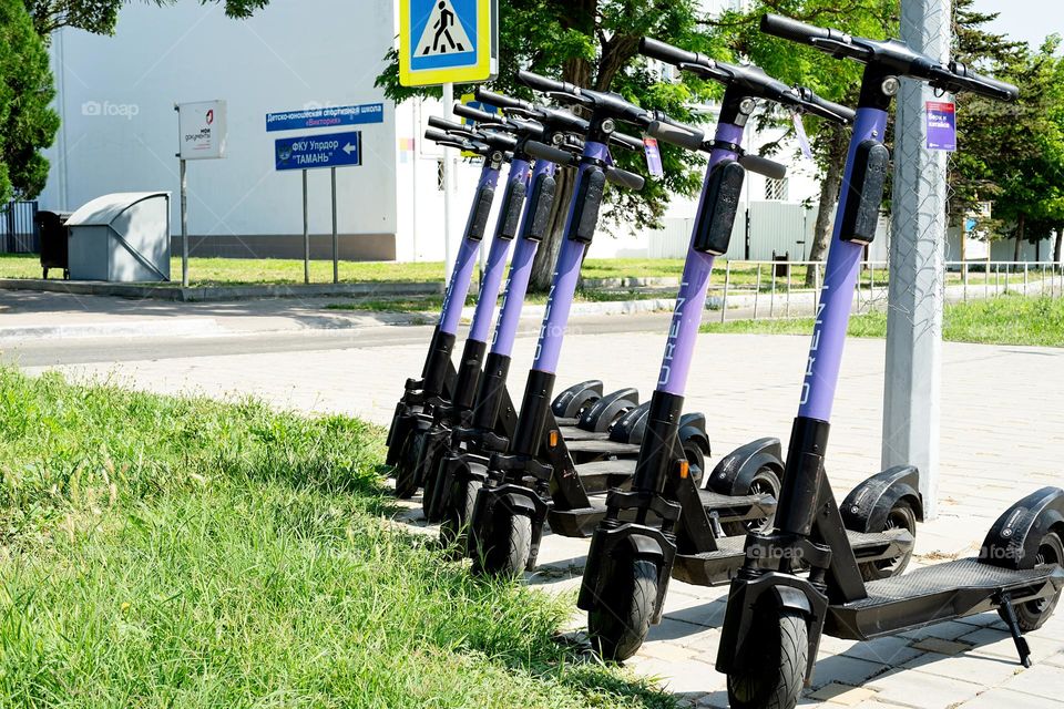 urent electric scooters on street parking