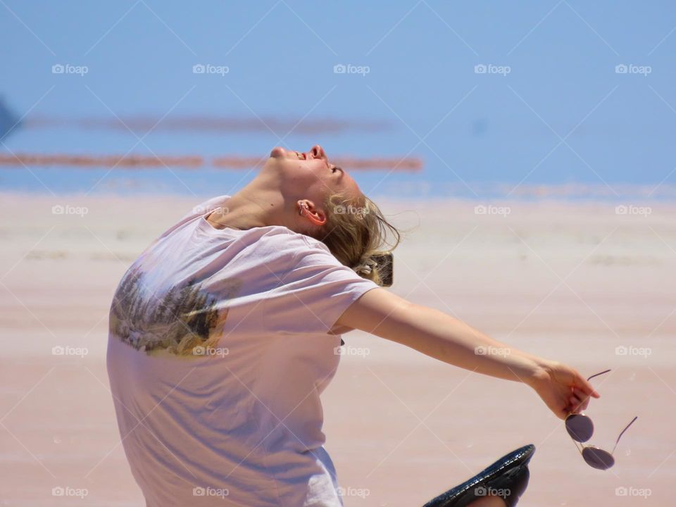Girl dancing on a salt lake.