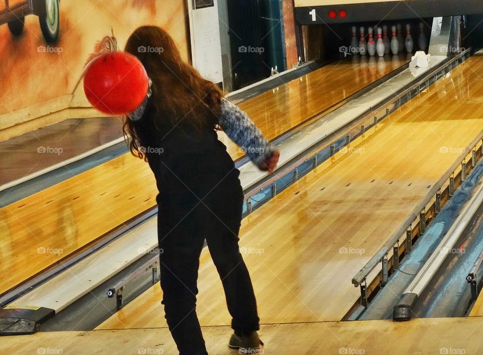 Girl Pitching A Ball In The Bowling Lane. Girl Throwing A Bowling Ball
