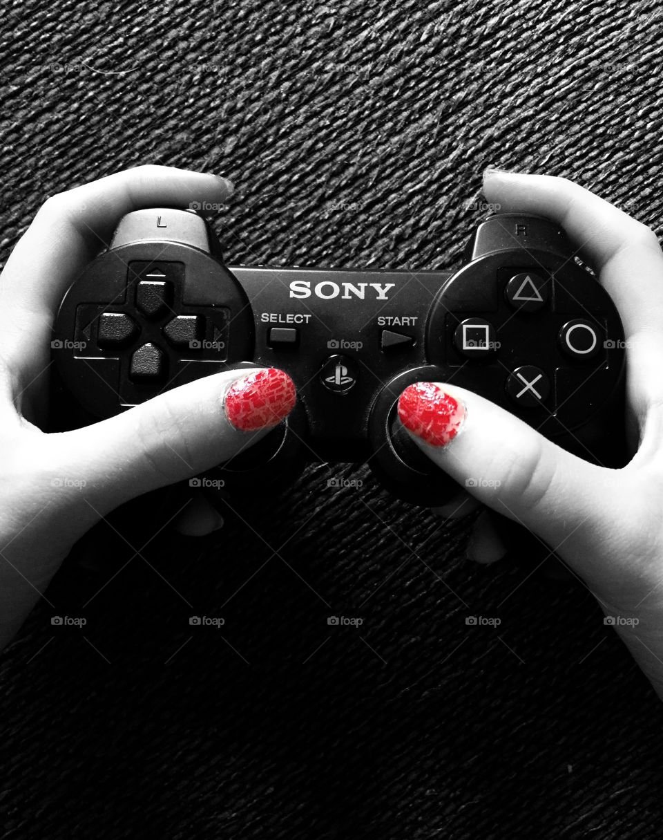 Gamer girl beating the boys with her red nails.