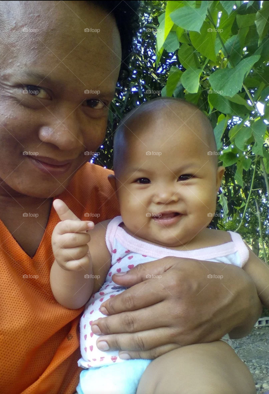 My niece gives a thumbs-up while taking a selfie