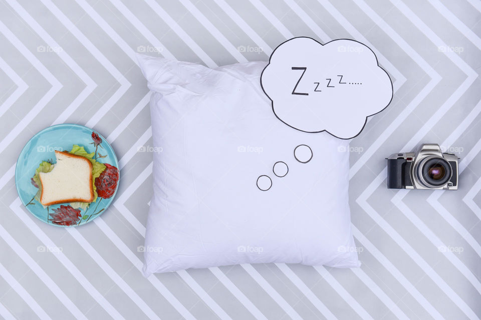 Eat, sleep, photography portrayed with a sandwich, pillow and camera