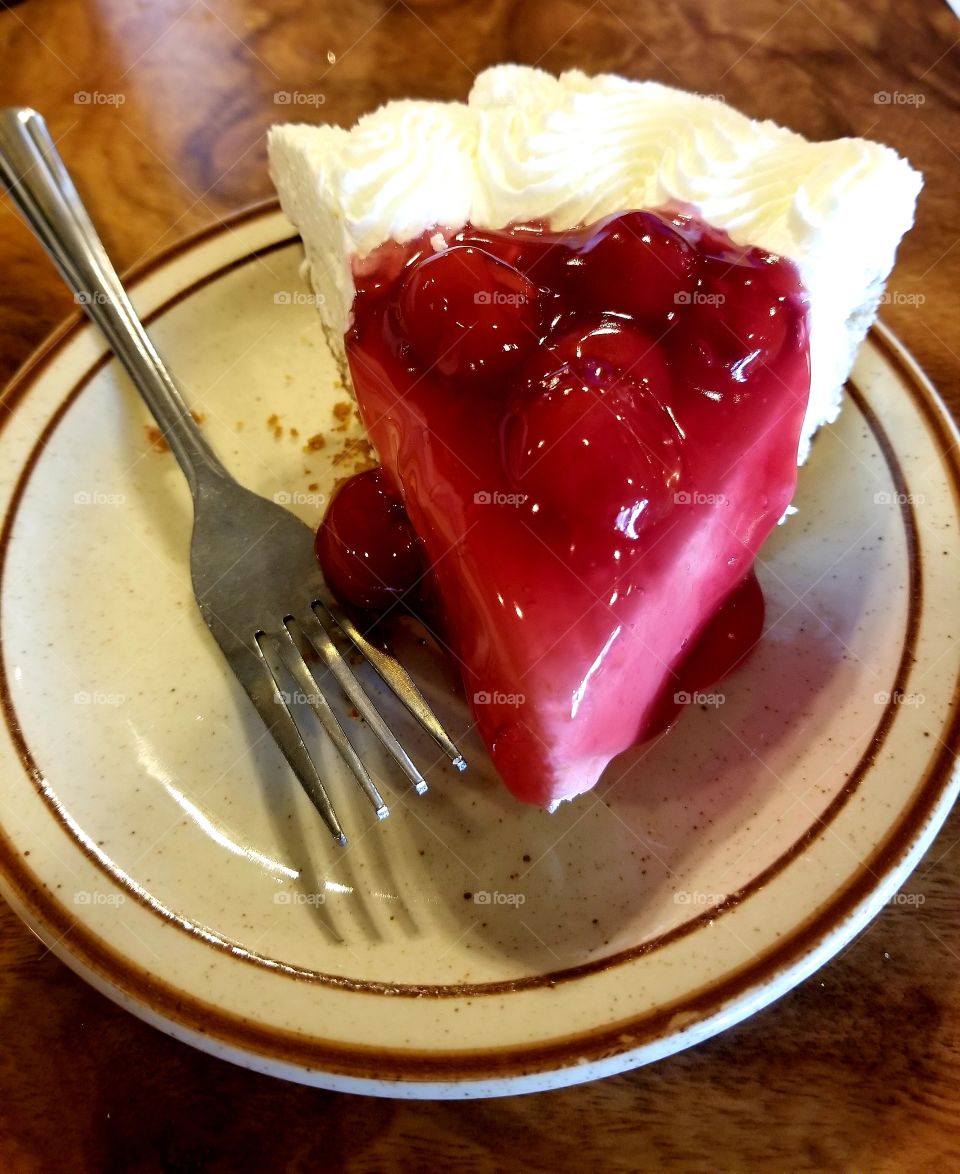 Cherry Cheesecake On Plate With Fork