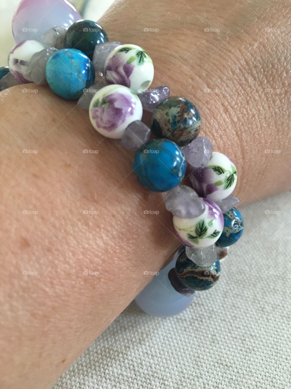 This beautiful beaded bracelet was a gift handmade with love. The colors are beautiful together but what stands out to me is the purple roses on some of the beads.