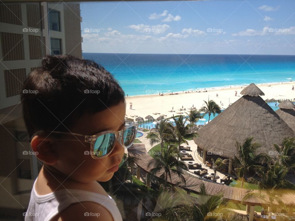 Baby at beach. Baby wearing sunglasses