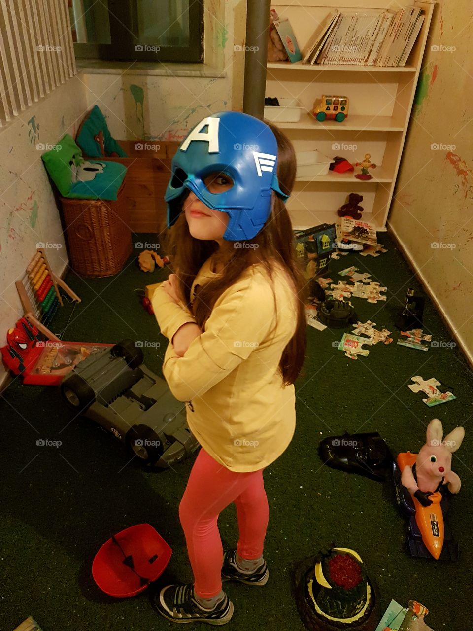Girl playing with a superhero mask