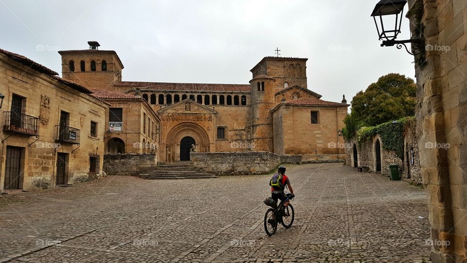 Cyclist travelling through Santillana del Mar, Cantabria, Spain.