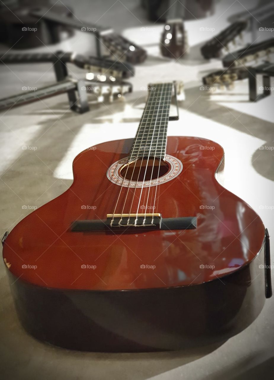 wooden guitar hanging on the wall