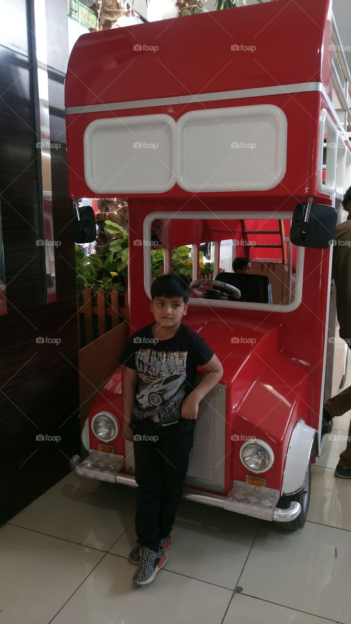 my son mehran was standing front of toy bus