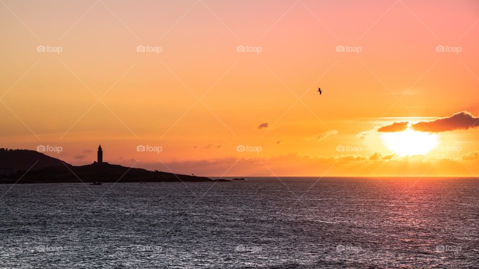 Lighthouse sunset at the ocean