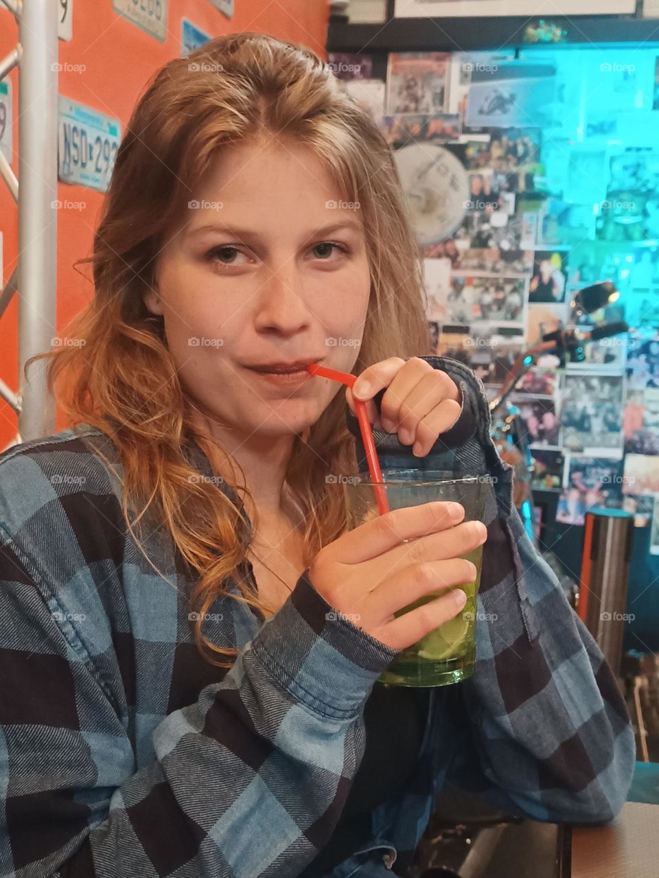 Young 21 years old woman drinking from a straw