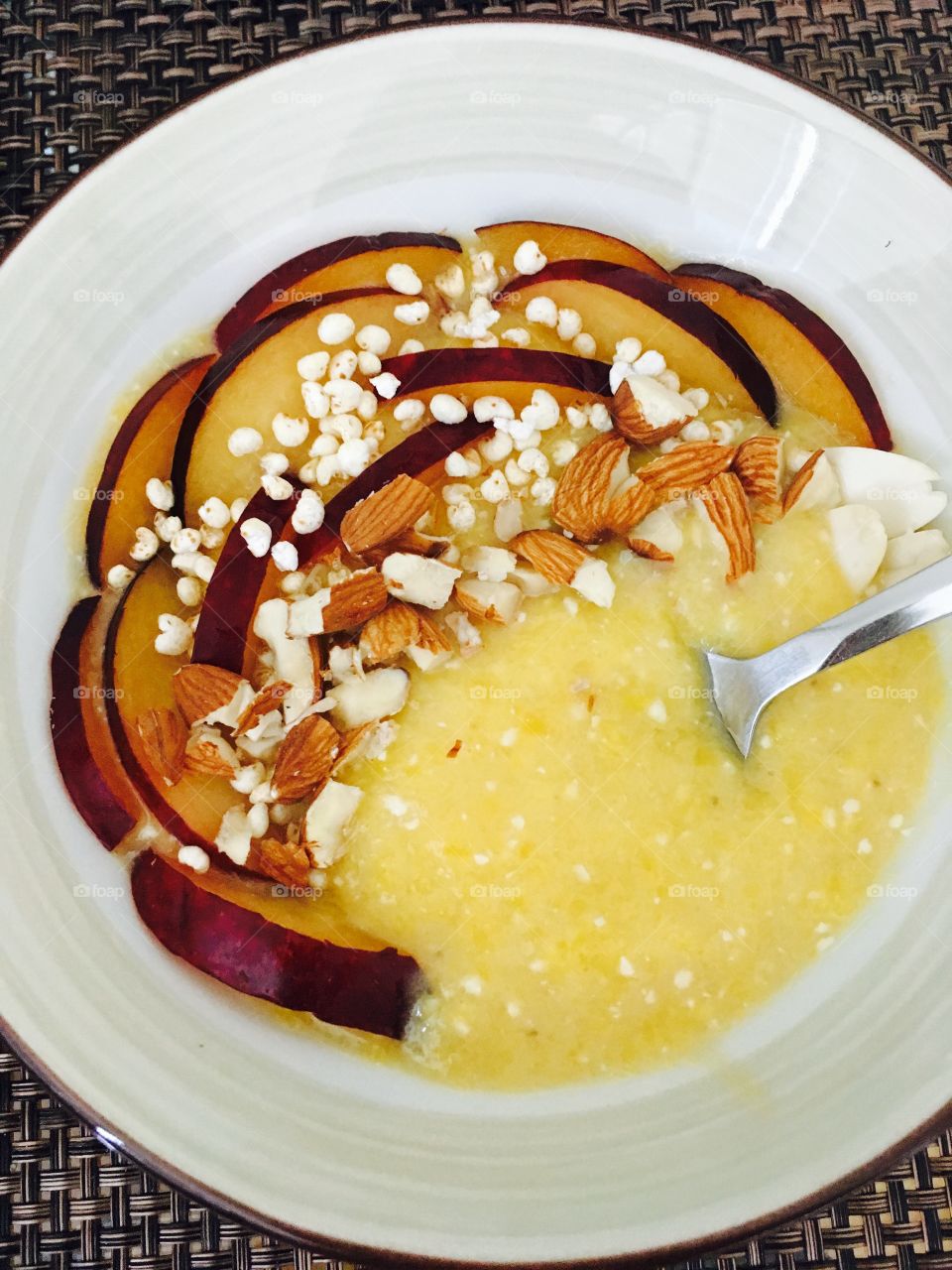 Mango smoothie bowl on table