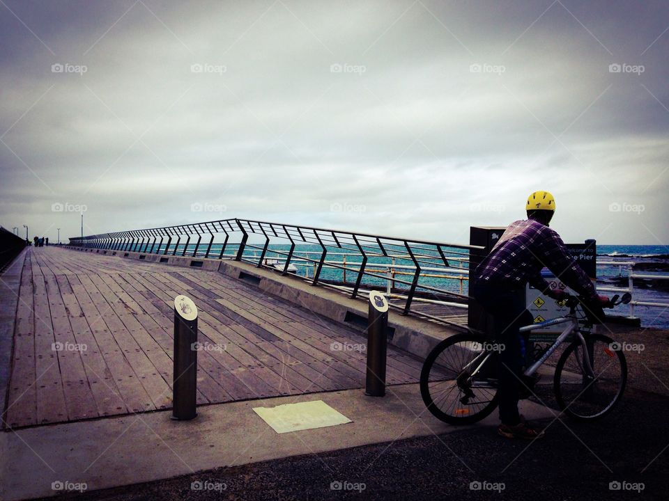 Cycling. Man on his bicycle at Lorne Pier, Australia