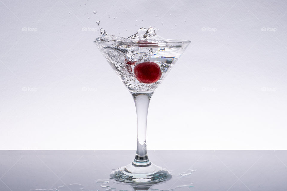 Fresh cherry falling into water