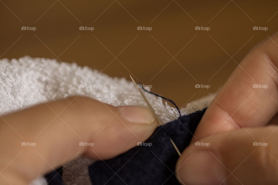 sewing towel with needle and thread