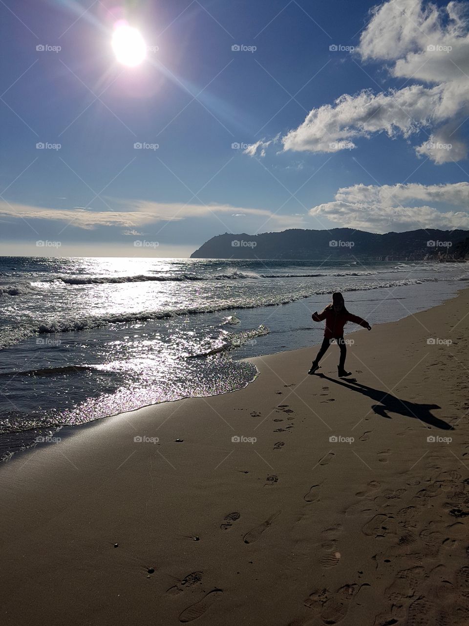 Girl having fun on the beach in italian Riviera