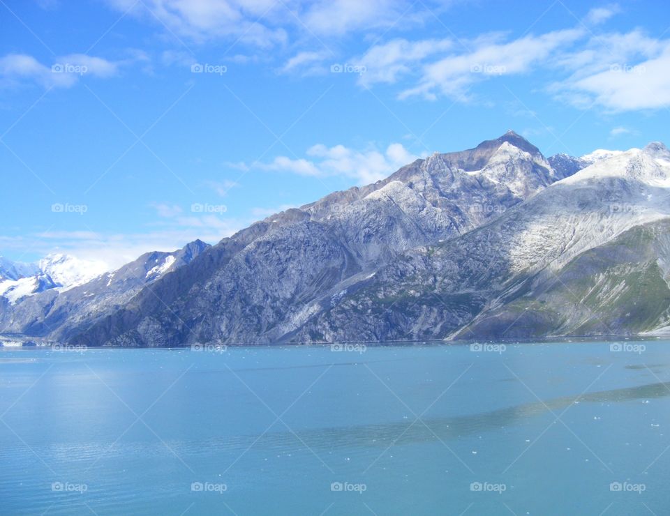 Calm Ocean waters, window view while cruising past glaciers and mountains in Alaska