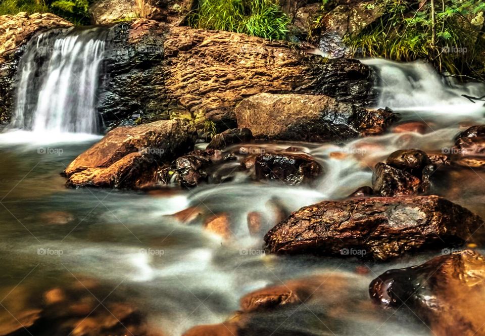 A rocky stream with small waterfalls in the heart of the Portuguese countryside 