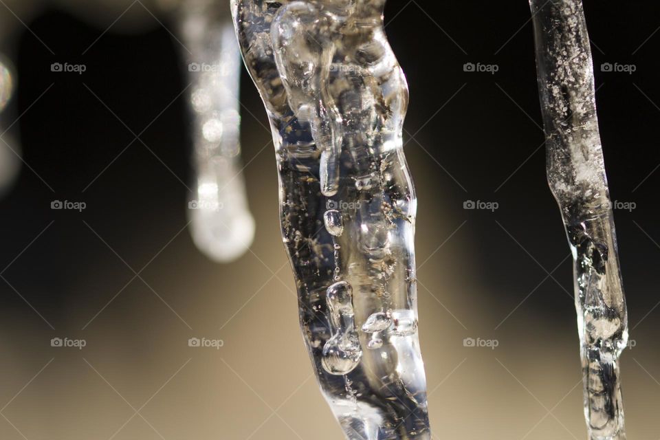 background of bright transparent icicles close-up.