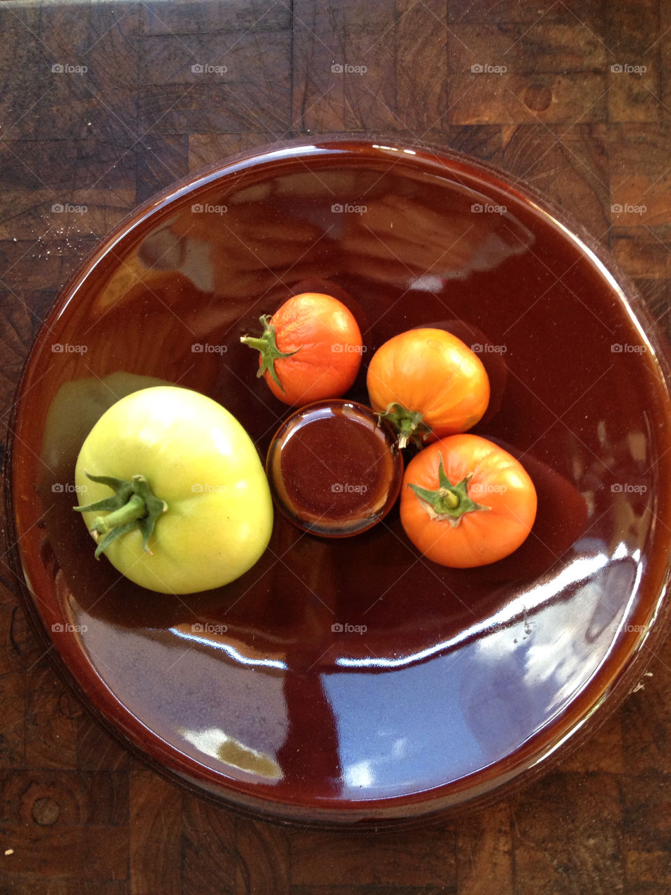Four tomatoes in a bowl