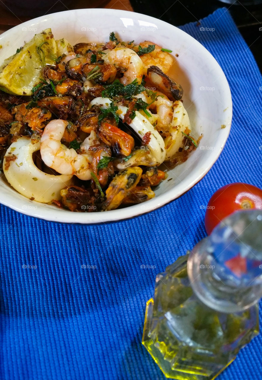 Calamari and other seafood with lemon and parsley